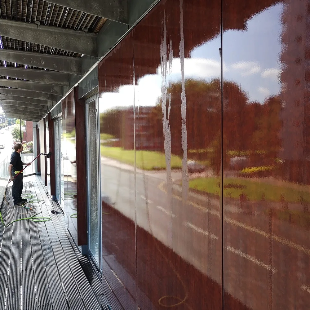 Cleaning the communal walkway glazing of an apartment block