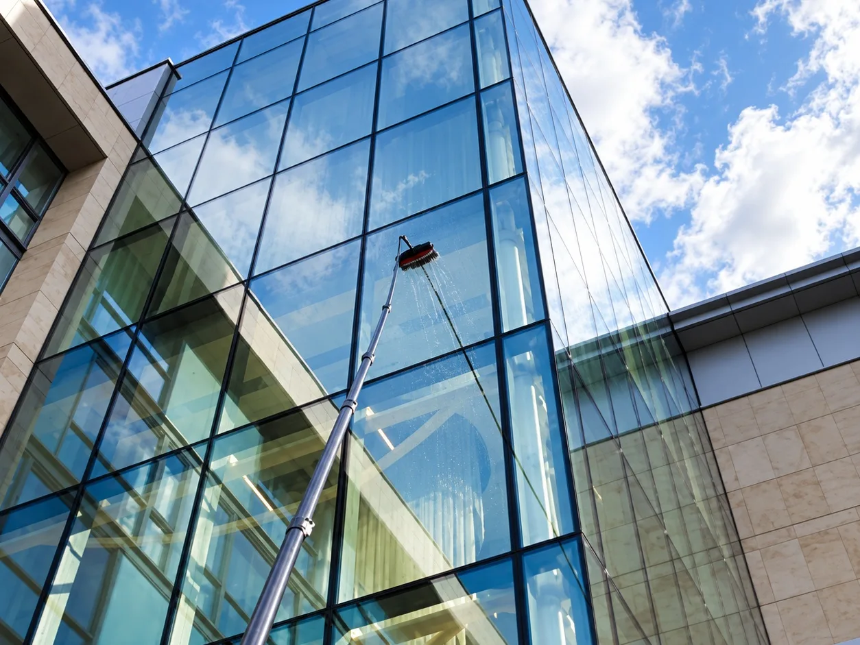 Water-fed pole reaching the upper glazing of a glass stairwell